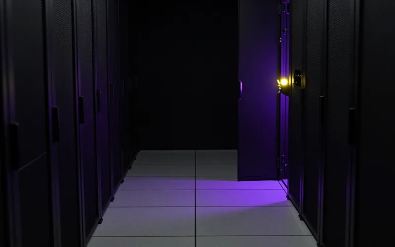 Open server rack door with a gloved hand resting on it
