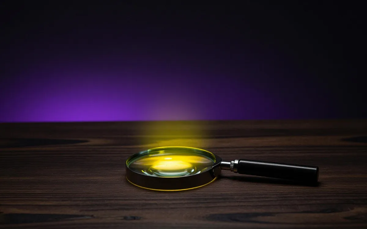 Magnifying glass on a dark desk