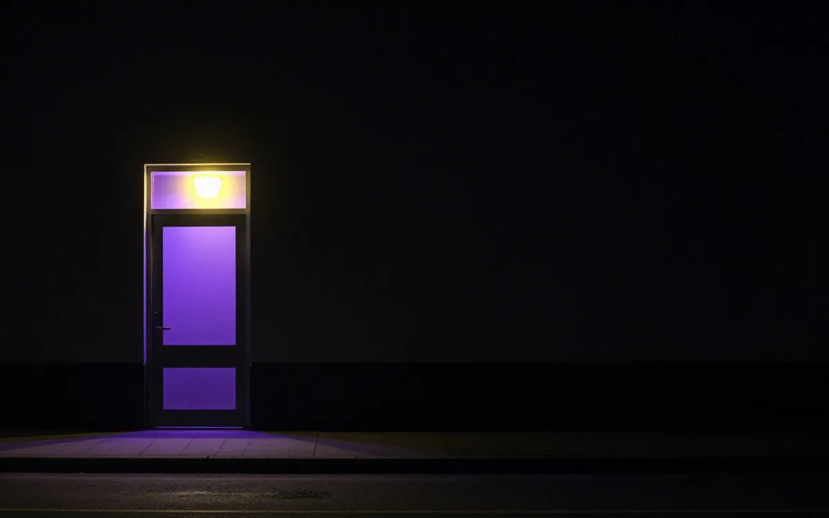Shop door with the blind pulled down at night