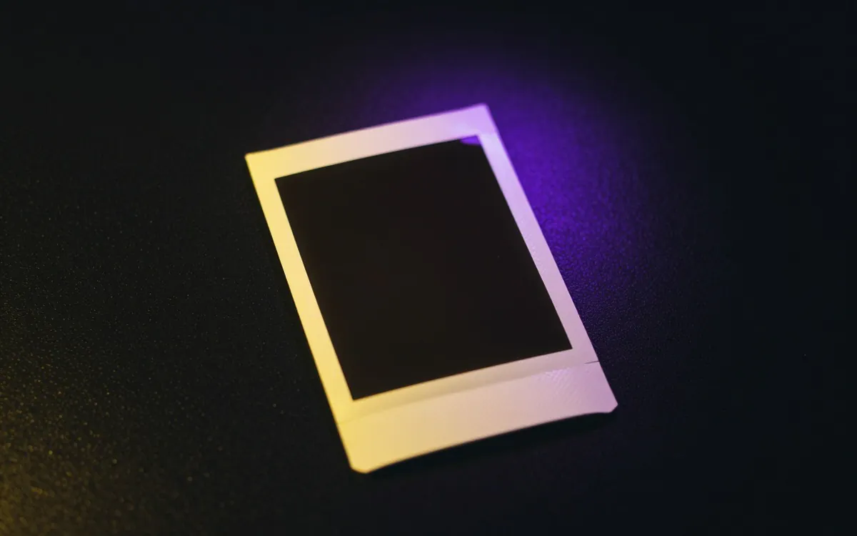 Blank instant photo print on a black table
